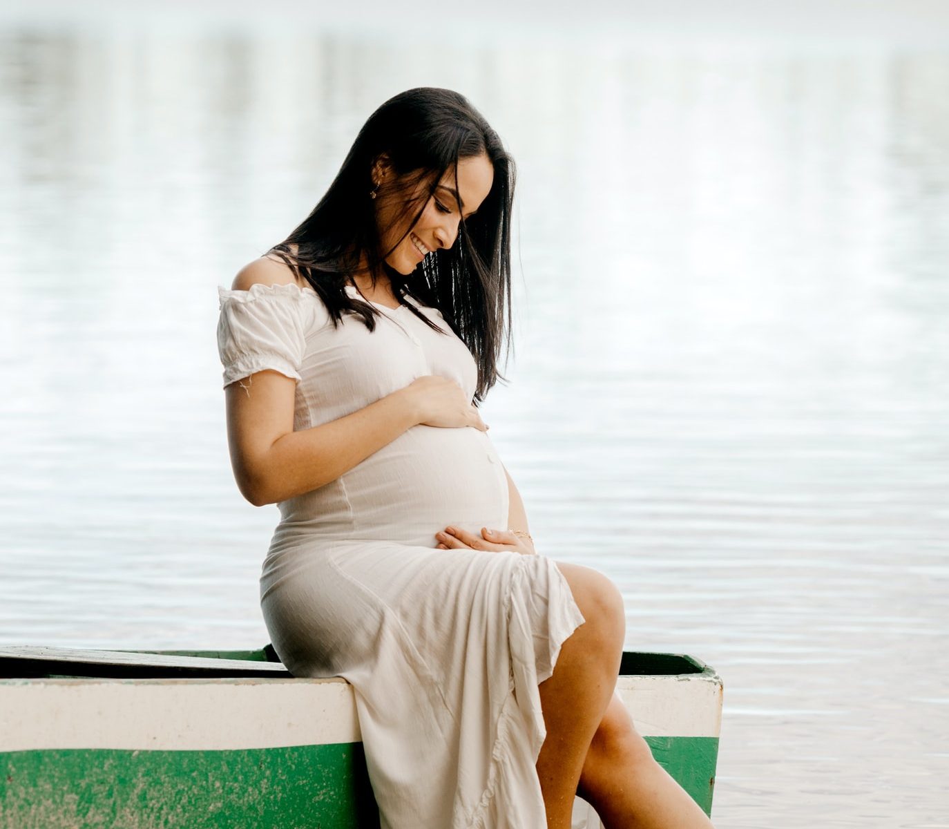 pregnancy photoshoot by a rustic lake