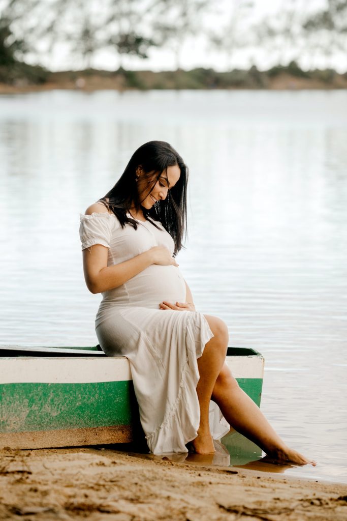 pregnancy photoshoot by a rustic lake